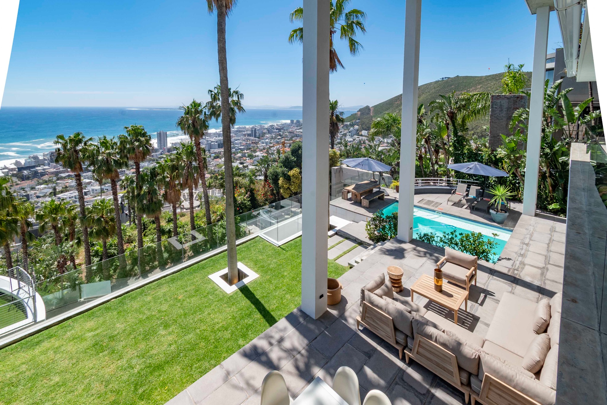 Palms, lawn and pool terrace overlooking the Atlantic from La Grande Vue