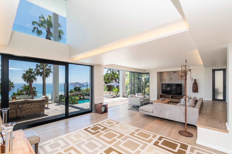 Tall windows and an open lounge connecting to the outdoor terrace